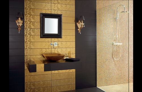 luxury black and gold tiled bathroom with a mirror and basin