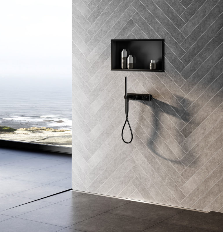 a glassless shower in a high rise building with grey tiles and a lineal drainage syste,